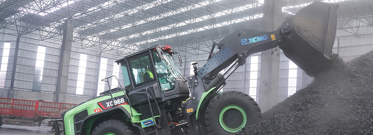 Wheel loader moving bulk material in a covered facility