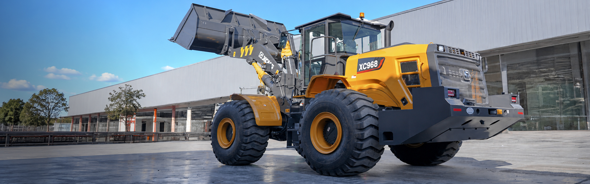XCMG wheel loader outside a modern industrial building