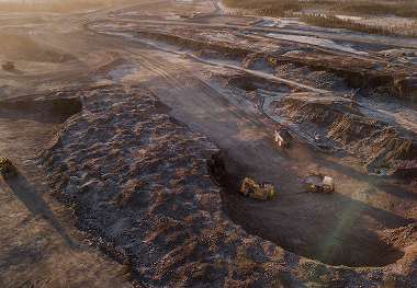 Aerial view of heavy equipment working across a large quarry site