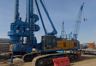 Large crawler crane parked at an equipment yard