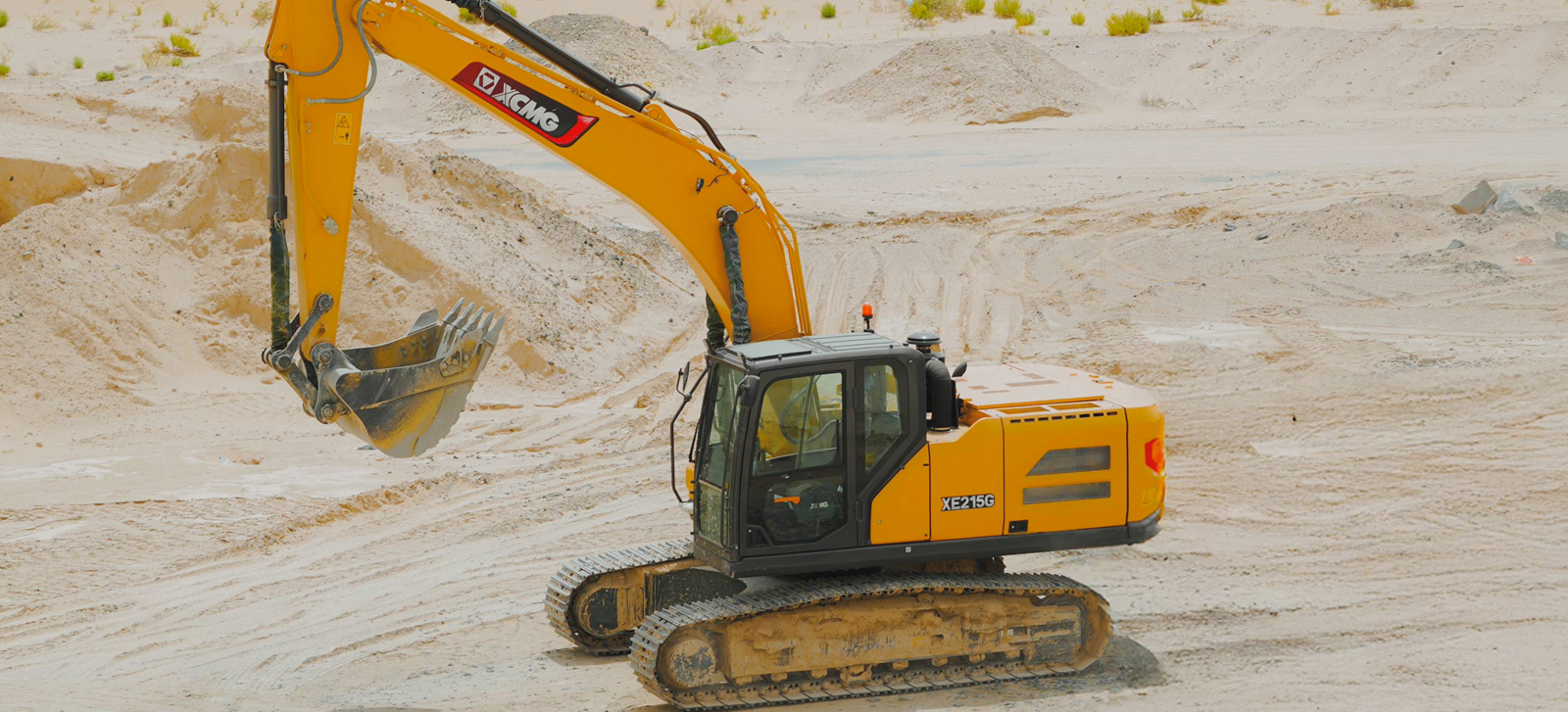 XCMG XE215C excavator operating on a highway project site