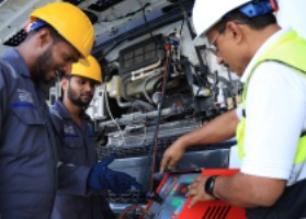 Technicians inspecting machinery components