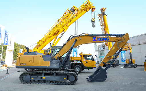 XCMG team walking in front of heavy cranes